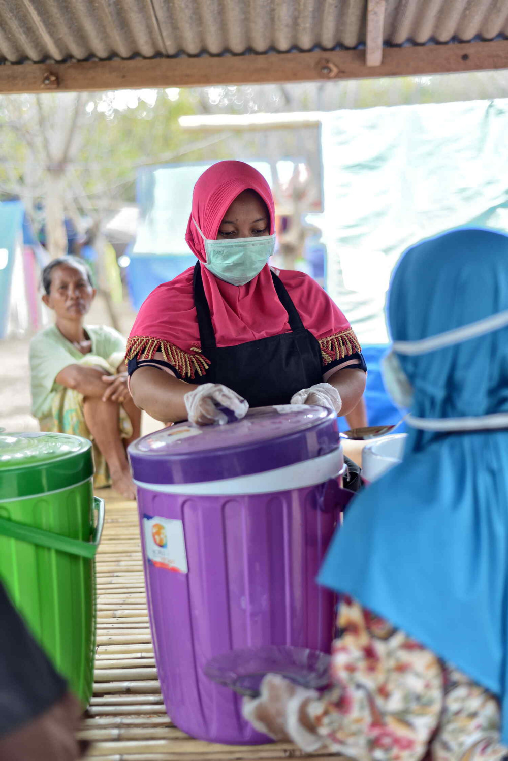 Serving food to victims after strong seven magnitude earthquake hit northern lombok
